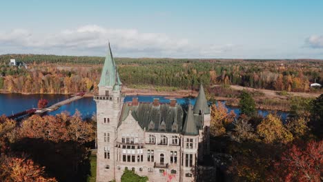 tracking shot towards teleborg castle in växjo, sweden, fall, orange and yellow leafs