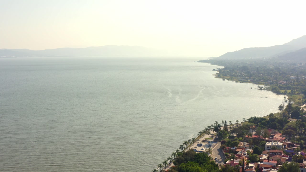DRONE: BEAUTIFUL SHOT OF AJIJIC PIER AT CHAPALA LAKE AT SUNSET