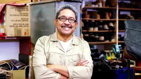 portrait of cobbler standing with arms crossed