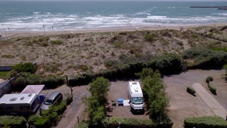 Aerial-view-of-camping-RV-can-parked-near-beach-in-South-France