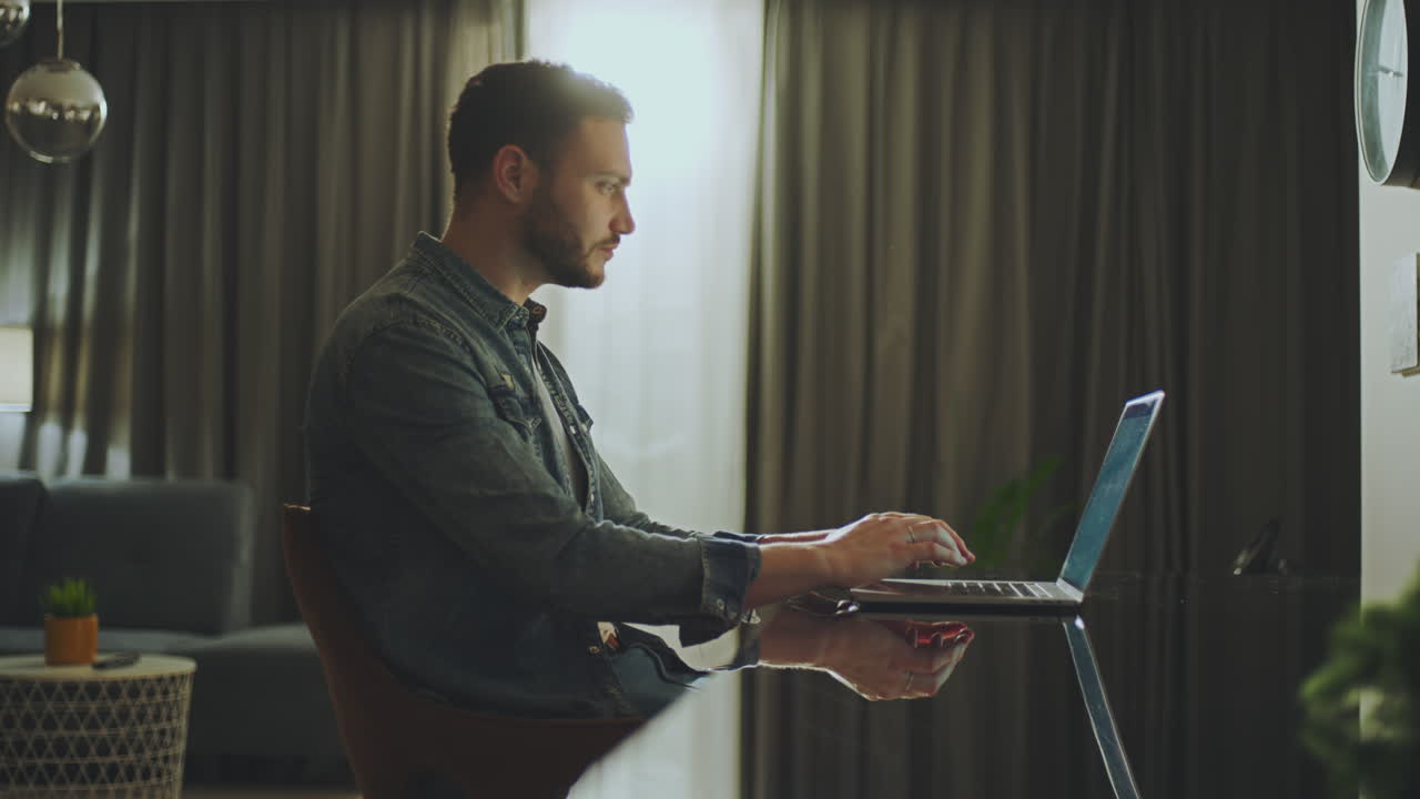 Man working on laptop at home