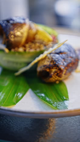 fried fish filet rolled on the vegetable layer. beautiful savory dish of seafood. close up. vertical video.