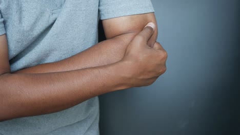 man holding his elbow in pain