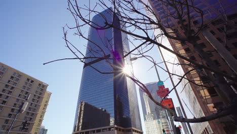 sun rays shine next to modern skyscrapers in downtown los angeles. la is a big financial business city. concept of american modern urban lifestyle, city life work in la. low angle shot downtown.