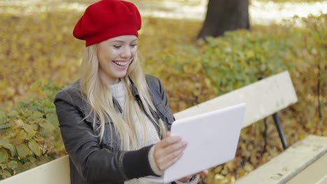 woman using video chat app in park