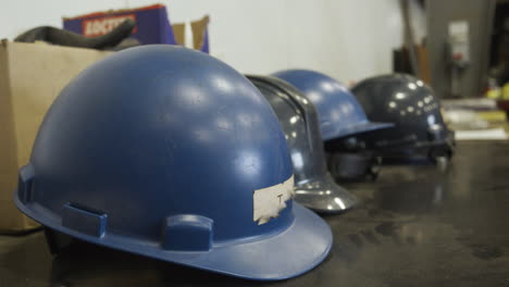 Blue-hard-hat-slider-shot-on-a-table---blue-collar-jobs