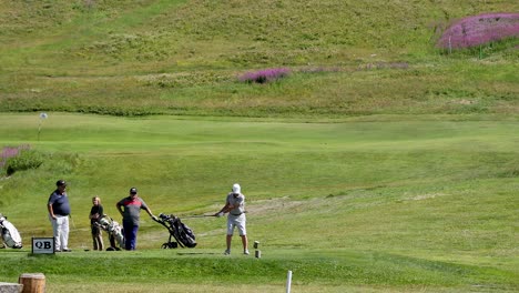 golfers preparing and hitting shots on the course