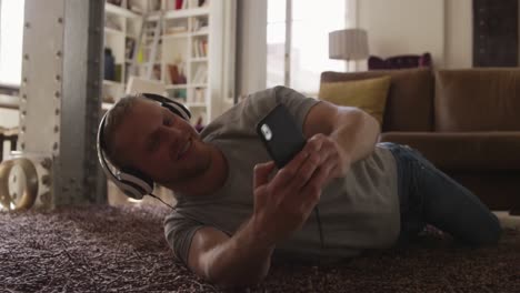 caucasian male in social distancing listening music at home