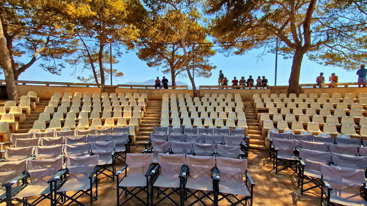 Venetian Fortezza Castle amphitheater with people sitting, panning view