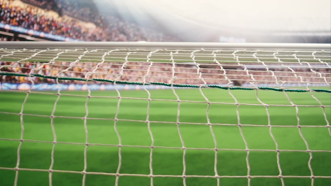 Close-up of soccer goal net crosses in selective focus foreground