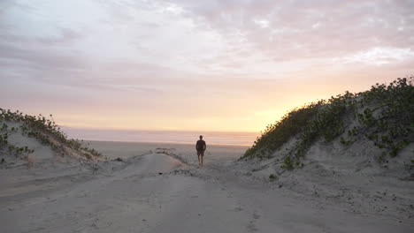 Silueta-De-Hombre-Caminando-En-La-Playa-Al-Amanecer-En-El-Este-De-Londres,-Sudáfrica