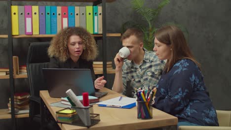 couple of potential buyers and woman real estate agent choosing property on laptop pc