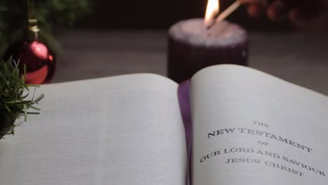 lighting candle at bible reading in christmas background