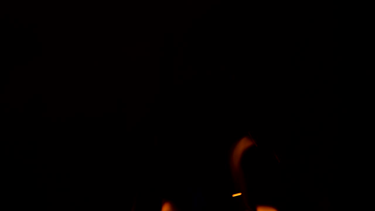 Sparkling, flying up sparkles for using in composition, vertical on black backdrop isolated. Screen mode for blending or transitions. Bright flames of fire on studio background, slow motion 50 fps 4k