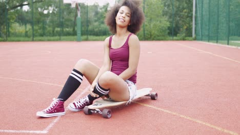 cheerful model posing on longboard