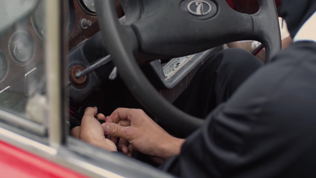 Man repairing vintage car