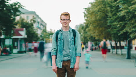 young man standing on city street