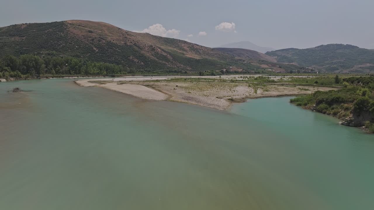 Vjosa River Albania Aerial v2 low flyover the pristine river, capturing its turquoise waters, sandy riverbanks and the rolling mountain landscape of Klos - Shot with Mavic 3 Pro Cine - July 12th 2024