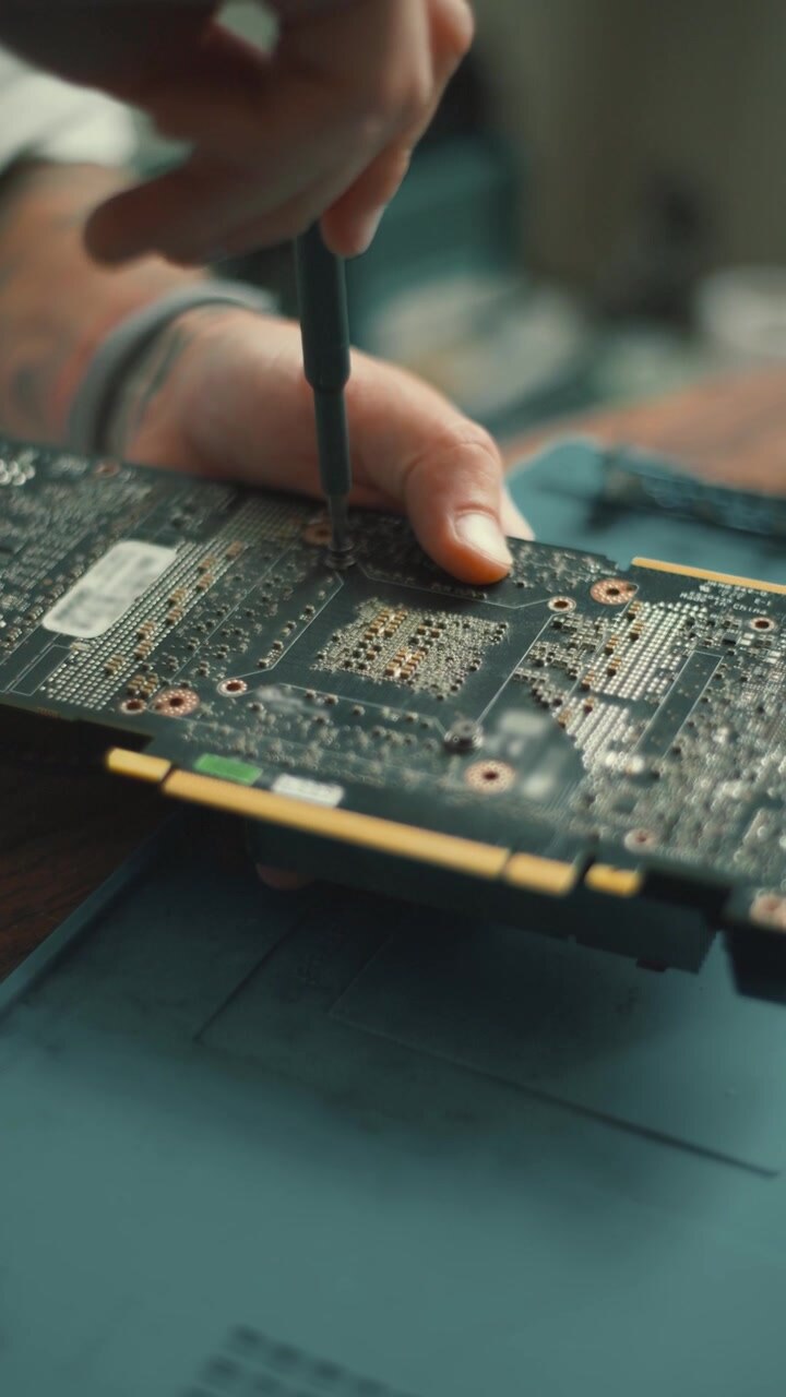 Repairing a graphic card at a workshop in the afternoon with careful attention to detail