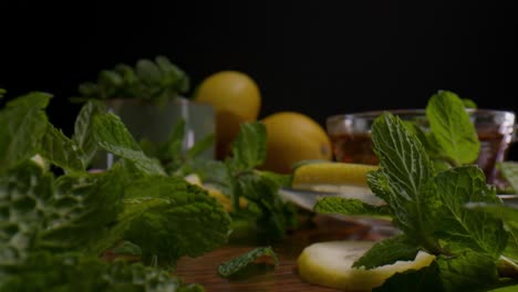 Mint-Leaves,-Slices-Of-Lemon,-And-Honey-On-A-Wooden-Table