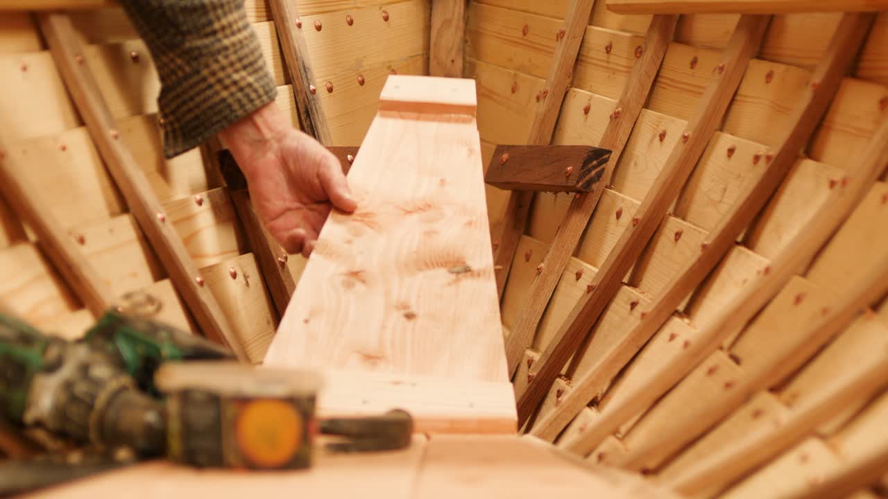 Boat Construction Fitting Interior Floor Boards at the Bow
