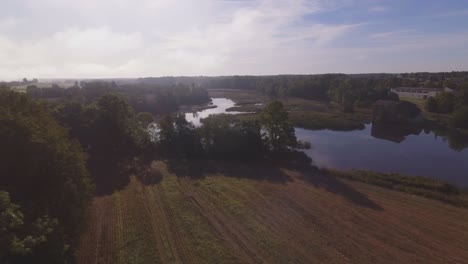 aerial flying forward over the meandering river drowned in the morning mist