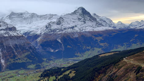 first cliff metal walk way grindelwald switzerland swiss alps snowy jungfrau junfrangu glacier lauterbrunnen mountain peaks october cloudy autumn evening landscape sunset static shot