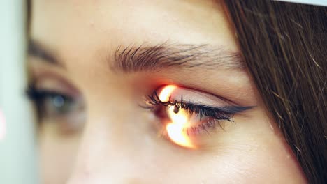 eyes examination. close-up woman's eyes checking by a doctor. laser shining inside the eye. eyesight concept.