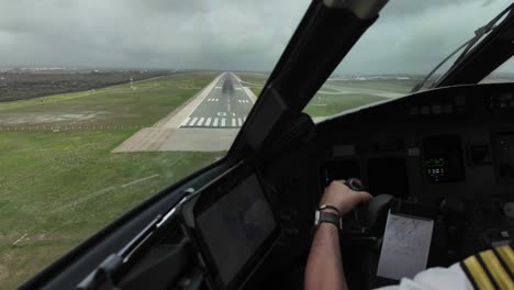 Immersive-pilot-FPV-POV-view,-Captain-side,-real-time-landing-at-Menorca-airport,-Spain,-in-a-cloudy-and-windy-winter-morning-with-moderate-turbulence