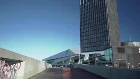 Slow-motion-tracking-shot-of-abandoned-streets-of-Iconic-Eye-Film-Museum,-A'dam-Tower-during-covid-19-pandemic-lockdown,-Amsterdam-North,-03-21-2020