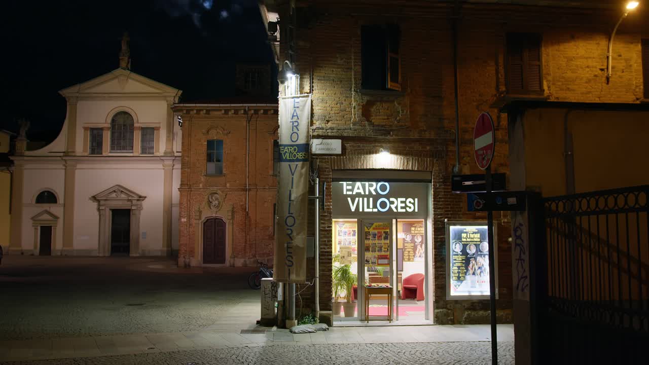 Wide shot of Monza's historic center under cool moonlight, evoking a calm, mystical autumn night.