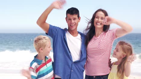 Cute-family-saying-goodbye-to-camera