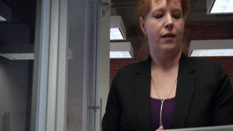 woman using a tablet at work while she walks