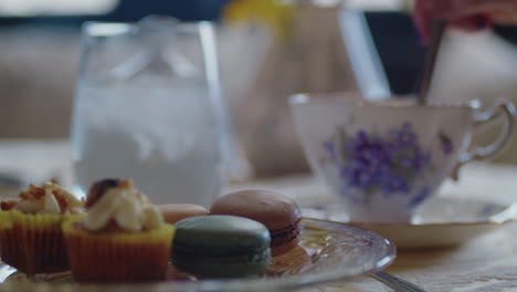 panning across table as the tea is stirred to reveal a beautiful plate of pastries