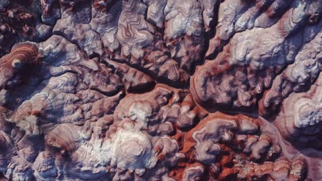 textured background of uneven surface of sandstone cliffs in sunlight