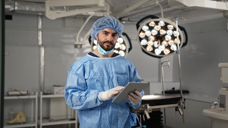 Surgeon reviewing tablet in operating room