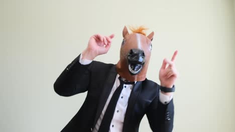 funny dance of businessman with horse head on olive background in studio funny dance of businessman with horse head on olive background in studio a man in a masquerade mask of a horse video