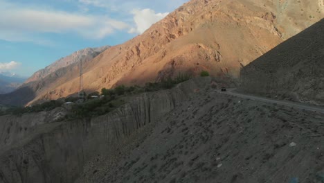 aerial beside winding mountain road at shandur pass in pakistan. dolly forward