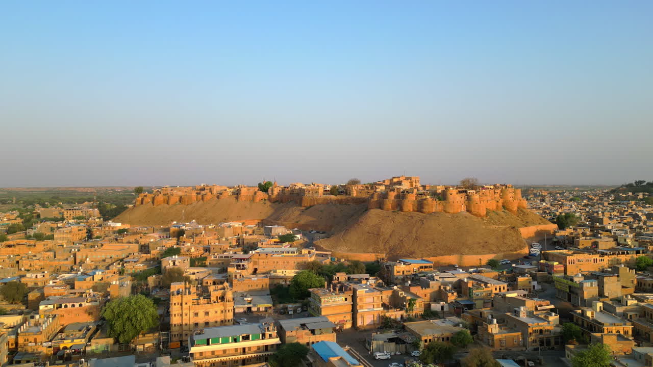 una impresionante vista de avión no tripulado 4k orientada hacia adelante que muestra el majestuoso fuerte de jaisalmer, también conocido como el fuerte dorado y el paisaje urbano de rajasthan en un día soleado, india