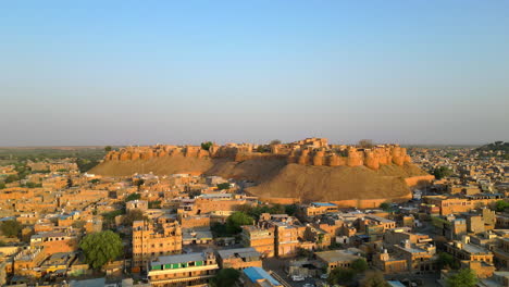 a stunning forward-facing 4k drone view showcasing the majestic jaisalmer fort, also known as the golden fort and rajasthan cityscape on a sunny day, india