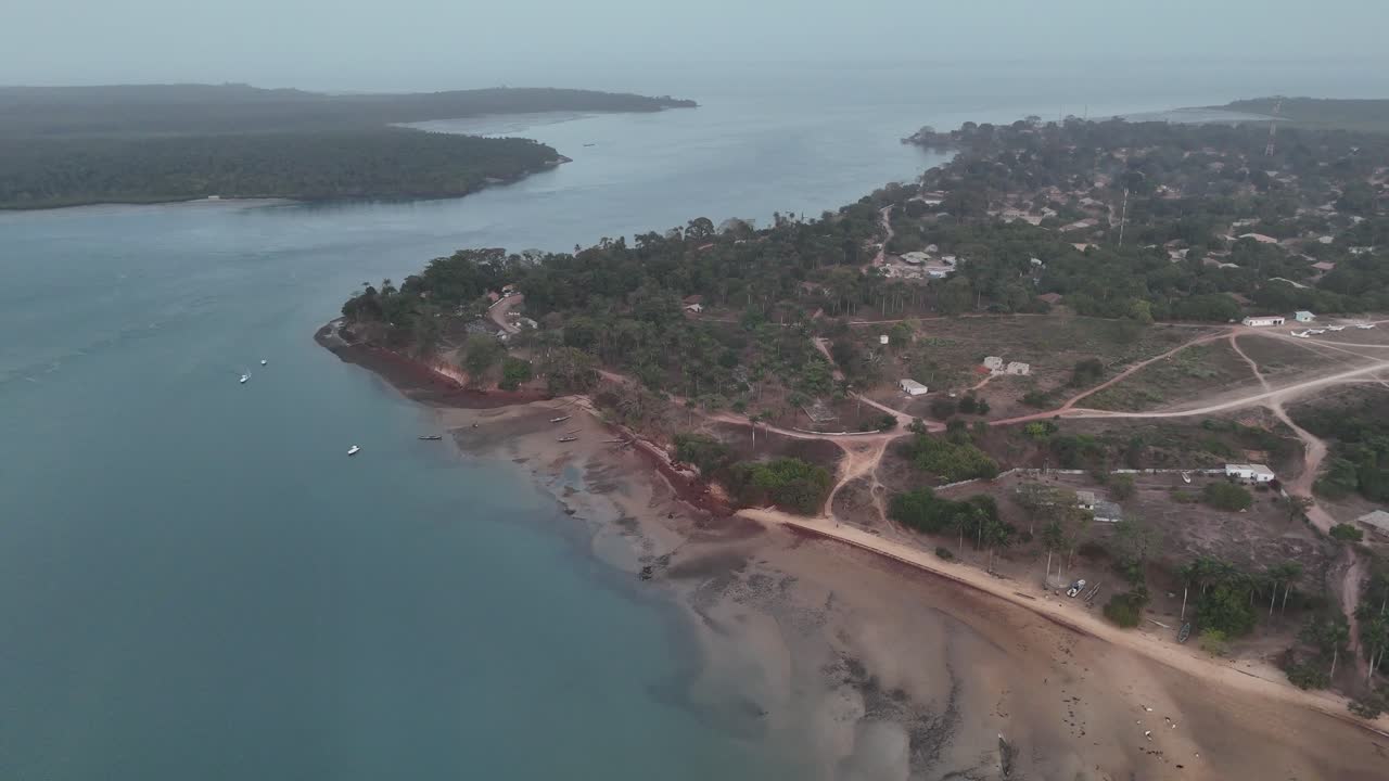 Drone view of small coastal settlement along the Atlantic shoreline of the Bijagós Islands, West Africa