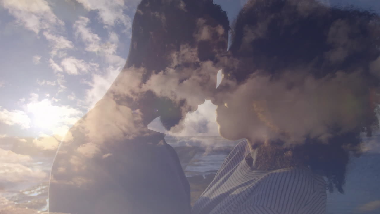 Embracing couple with animation of clouds and sky overlay in background