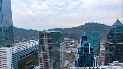 Aerial-hyperlapse-close-to-buildings-in-the-financial-center-of-Santiago-Chile-on-a-cloudy-day-with-high-rush-hour-traffic