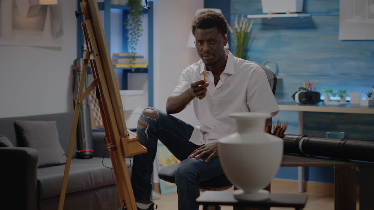 African american artist looking at vase design for inspiration