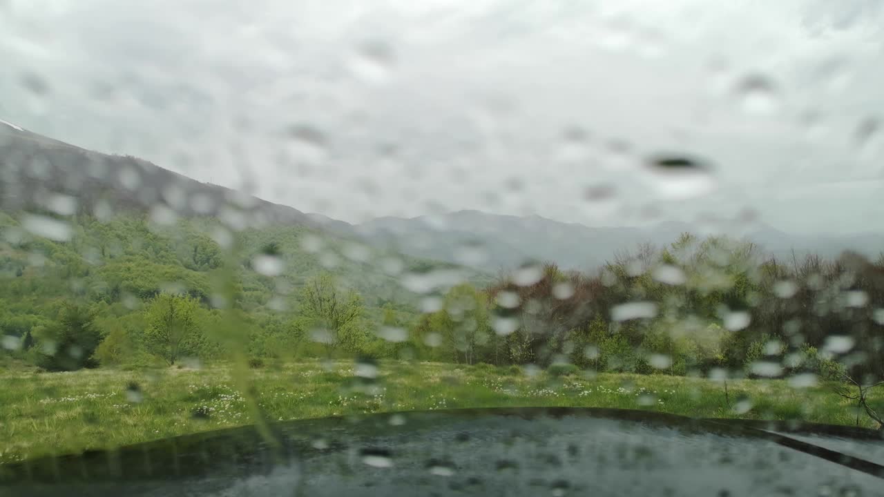 Spring rain through the glass of an SUV