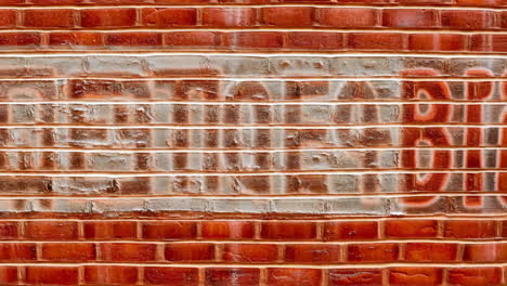 textured red brick wall with faded paint