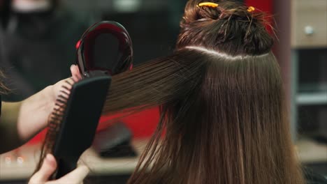 woman getting her hair styled at a salon