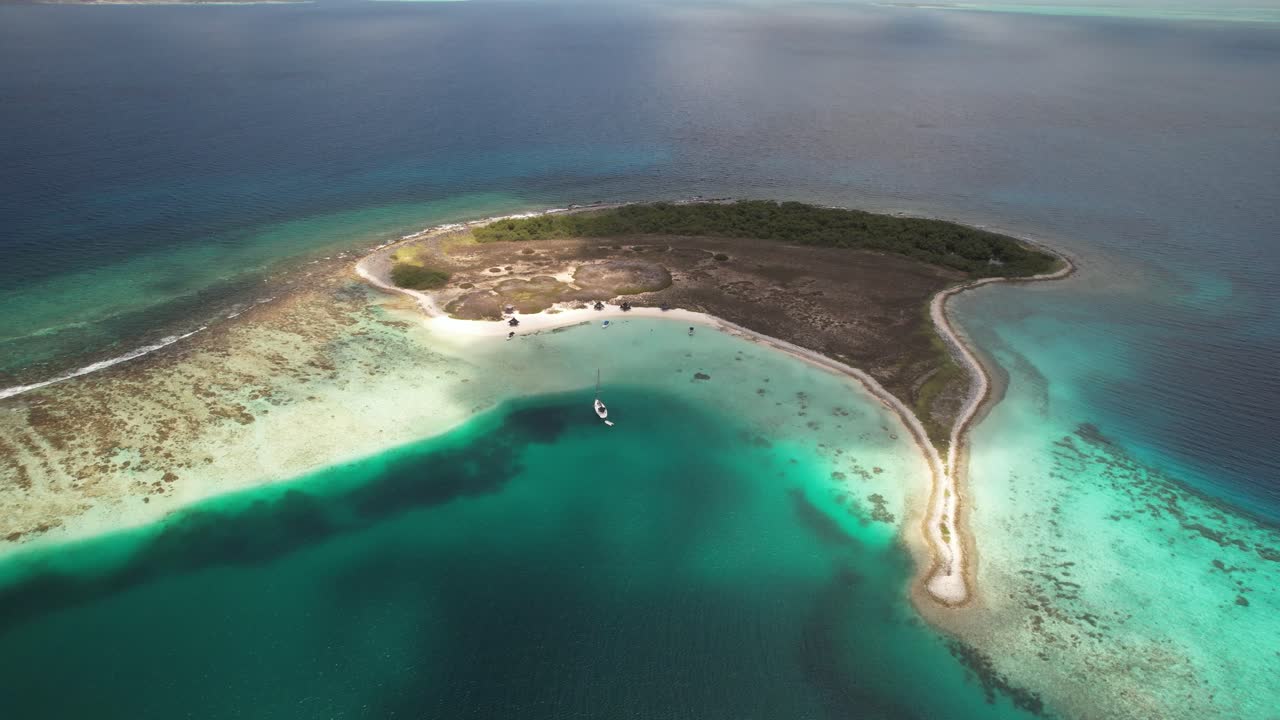 Tropical island with turquoise waters and sandy beaches seen from an aerial perspective