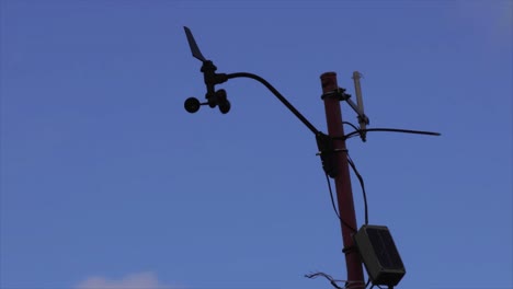 Anemometer-tracking-the-wind,-standing-against-open-sky,-a-vital-tool-in-monitoring-atmospheric-conditions