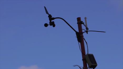 anemometer tracking the wind, standing against open sky, a vital tool in monitoring atmospheric conditions